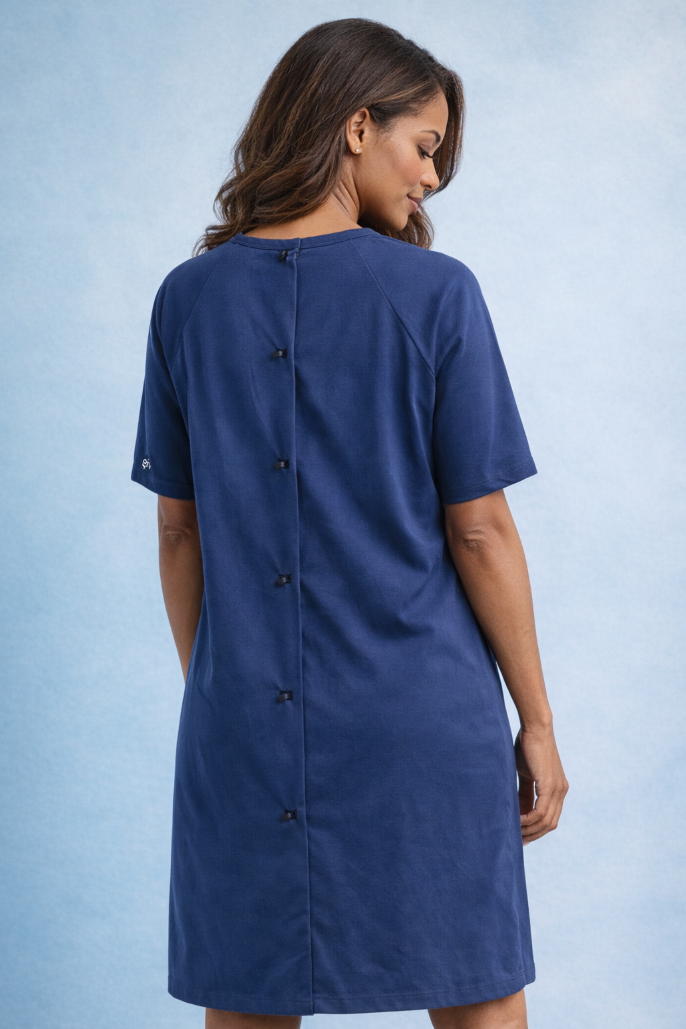 Back view of a woman wearing a navy GIV Gown