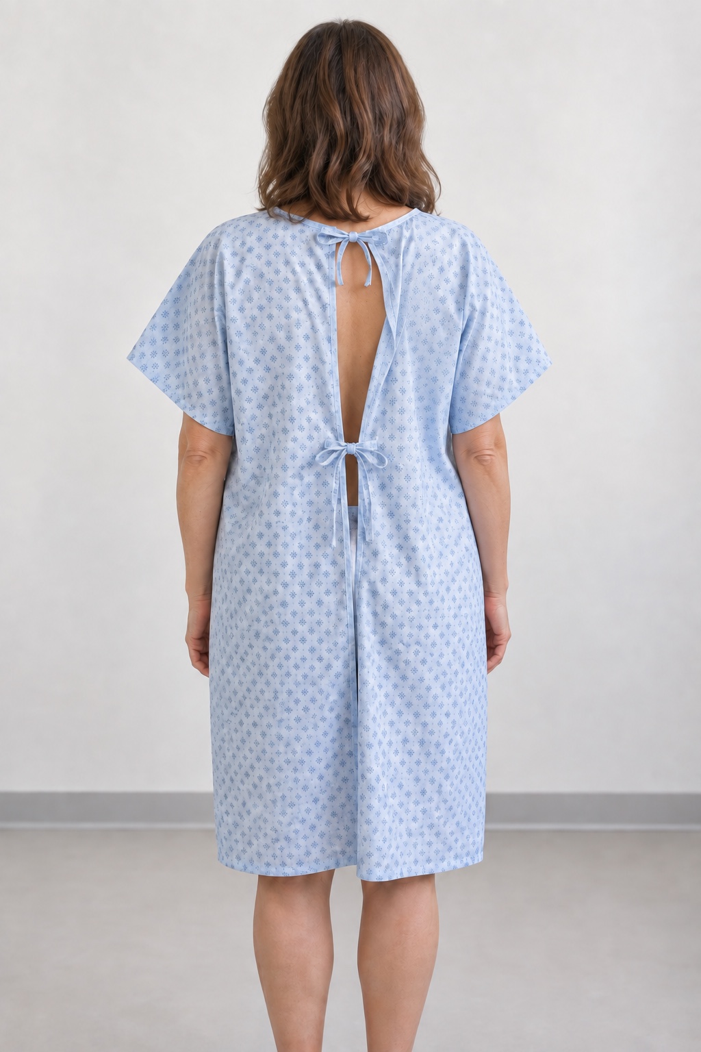 Back view showing the ties and open construction of a traditional patient gown